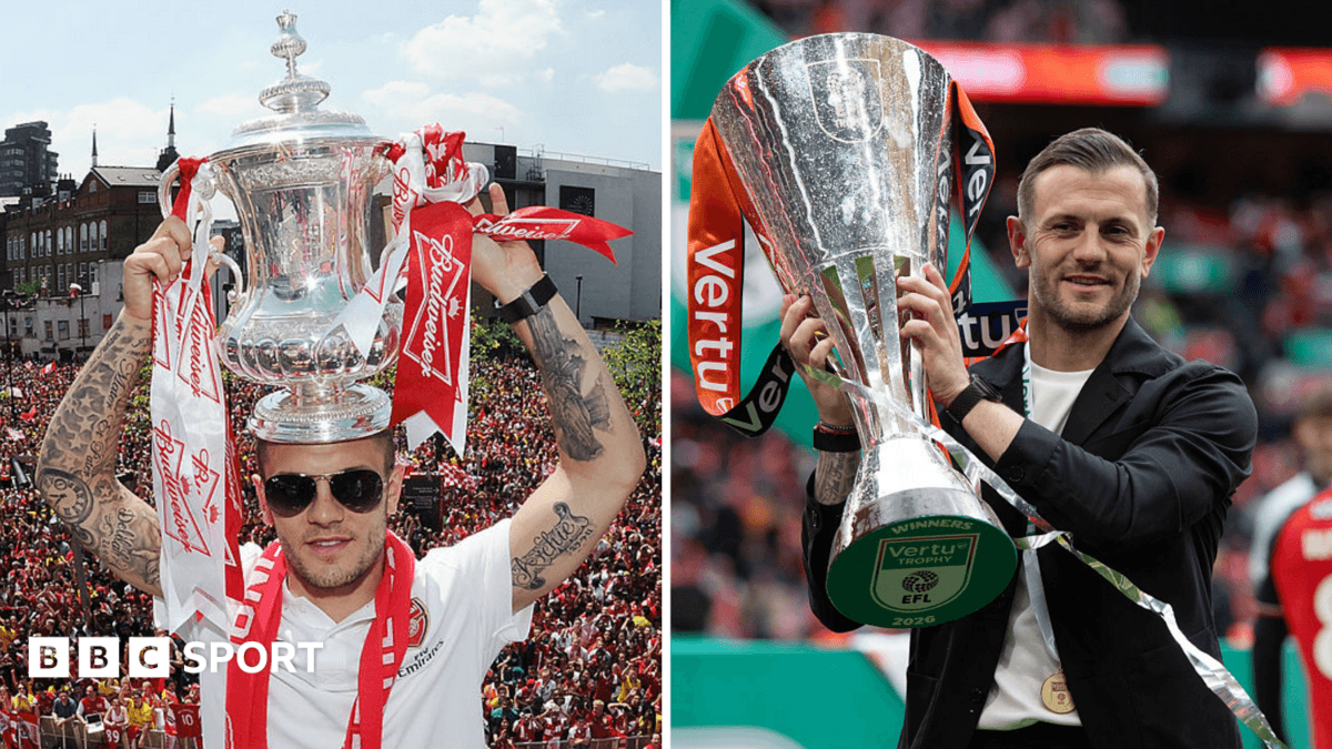 Jack Wilshere holding the FA Cup and the Vertu trophy